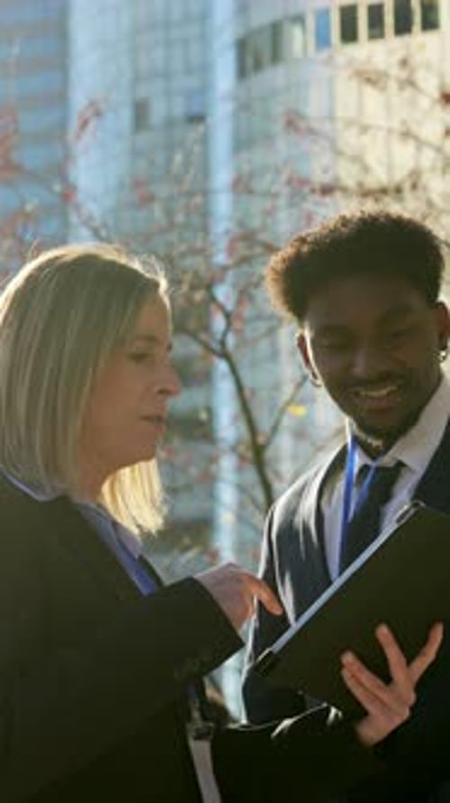 Woman and Man Using Tablet for Business