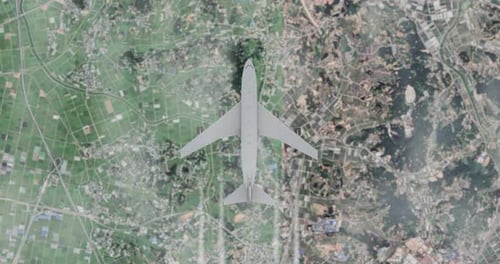 Aerial View of Airplane Flying Over Rural and Urban Landscape