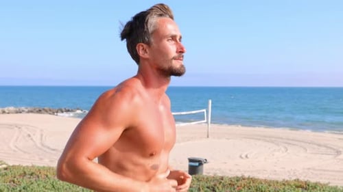 Athletic Man Exercising At The Beach