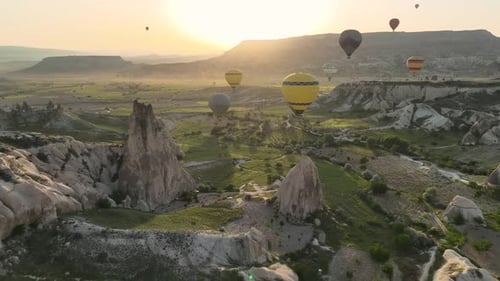 Hot Air Balloons Fly Over the Mountainous Landscape of Cappadocia Turkey