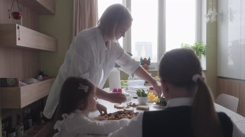 Mother Prepares Healthy Breakfast and School Snacks for Her Daughters in the Kitchen
