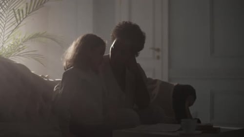 Couple Embracing Intimately in a Bright Apartment