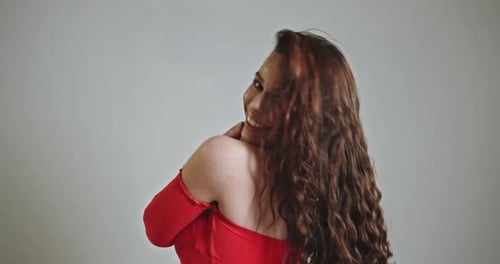 Beautiful Woman Posing in Red Dress with Gold Necklace
