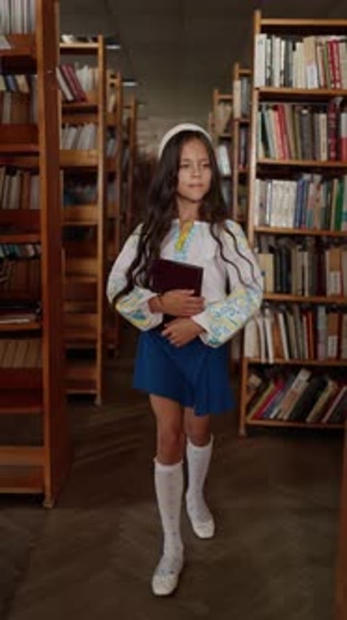 School Girl Holding Book in Library Concept of School Education
