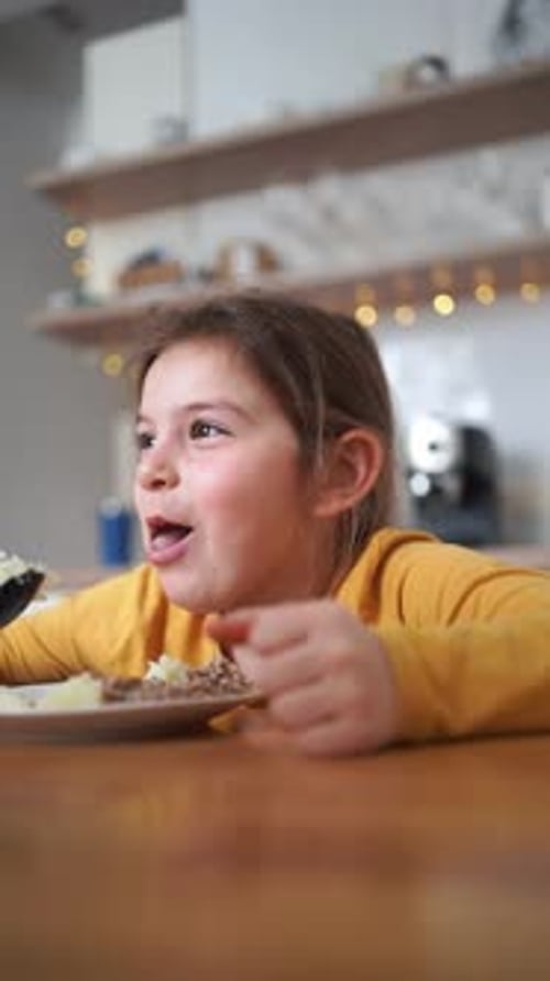Child Enjoys Meal at Kitchen Table