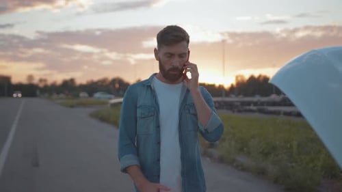 Man Calling from Roadside near Broken Down Vehicle