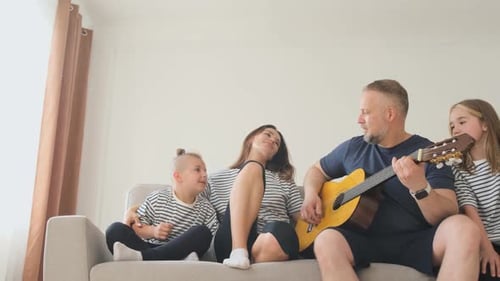 Family Togetherness: Father Playing Guitar with Children
