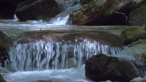 Closeup of a stream finding its way through a rocky stream bed