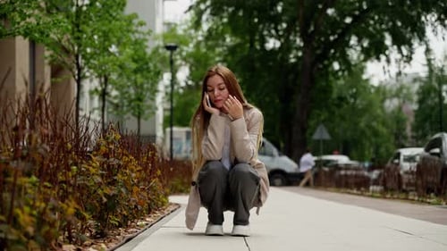 Auburn Haired Woman Talking on Cell Phone in City