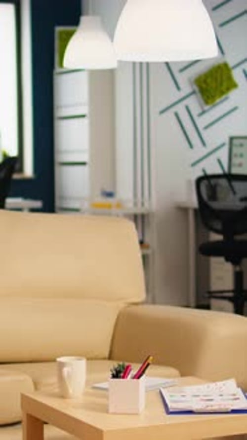 Interior of Cozy Light Company Room with Small Table and Confortable Couch