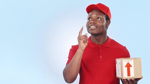 Thinking, pointing and black man with delivery box, package and parcel on blue background