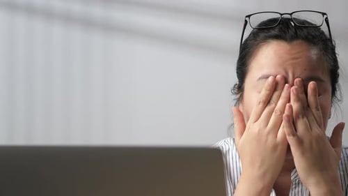Tired Woman with Eye Strain Rubbing Eyes