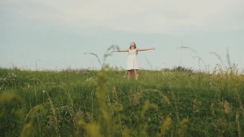 Footage of Fascinating Little Lady Raising Hands in Green Field Outdoor Physical Activity Summertime
