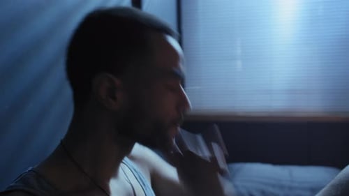 Man Drinks Alone in Dark Room