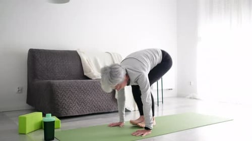 Senior Woman Practicing Yoga at Home