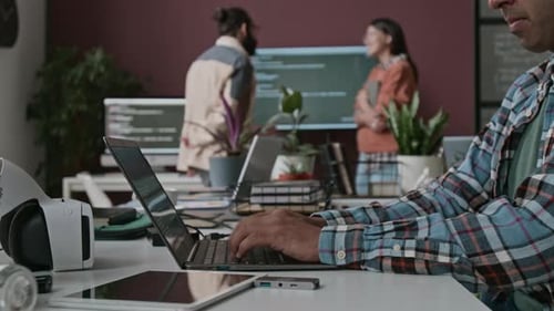 Anonymous Developer Typing Code on Laptop at Big Tech Company