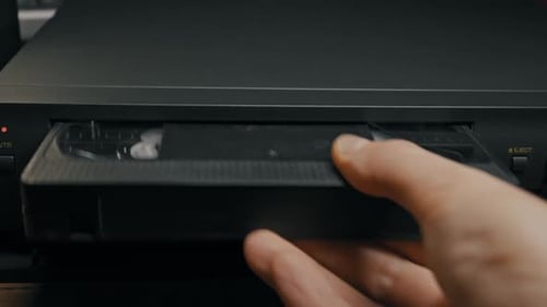 Inserting VHS Tape into VCR Player Device