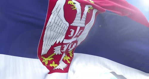 National Flag of Serbia Waving in Wind with Blue Sky