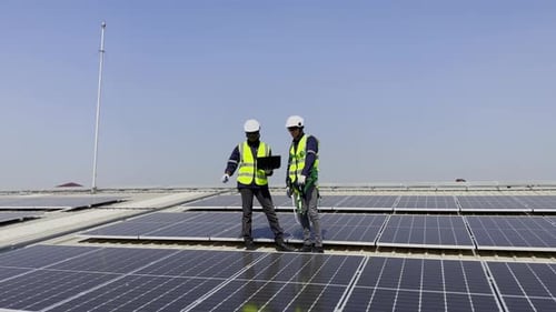 Technician installing solar cell. Installation and maintenance of solar cells on rooftop.