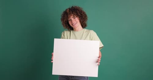 Happy Woman Holding Blank Paper in Green Background