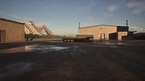 Paisaje industrial con edificios de almacenamiento y remolque al atardecer