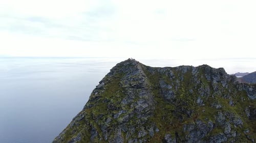 Aerial view of mountain hikers overlooking Lofoten Islands, Norway.