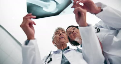 Doctors Analyze X-Ray in Hospital Low Angle