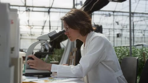 Woman Using Microscope for Scientific Research