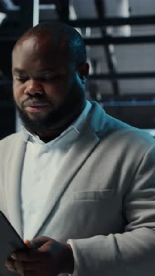 Vertical Video Data Center Engineer Monitoring Servers Performing AI Training