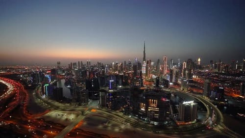 Time lapse of Burj Khalifa and skyscrapers. Evening falls on the city