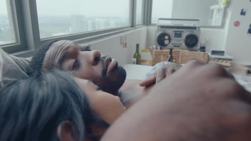 Loving Couple Lying Together Indoors at Home