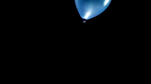 Blue Balloon Floating Against a Black Background