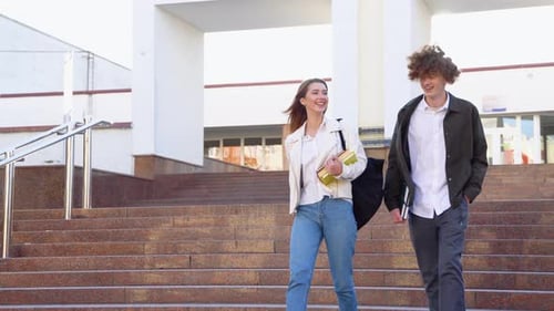 Two Stylish Students Walk Near the Campus and Smile