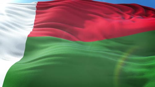 Realistic Madagascar Flag Waving in Blue Sky