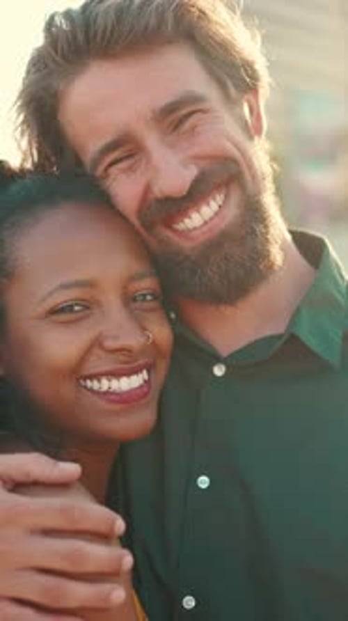 Close-up of happy interracial couple in the port, backlighting