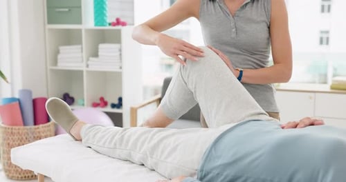 Physical Therapist Working With a Patient at a Clinic