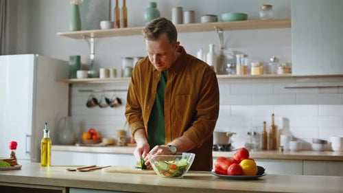 Relaxed Guy Chopping Cucumber Cooking Healthy Breakfast at Kitchen Closeup