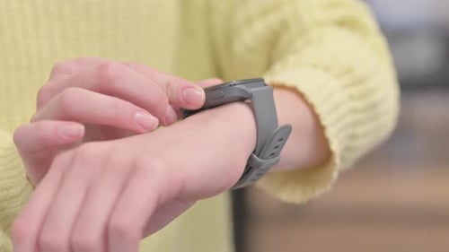 Close up of Female Hand using Smart Watch