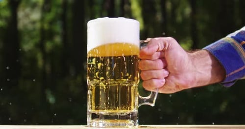 Golden Craft Beer Poured Outdoors Beer Splash Against Green Nature Background Pouring Amber Ale in