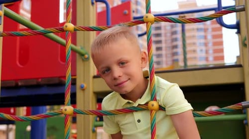 Child Boy Climbed on Top of the Rope Web on Playground