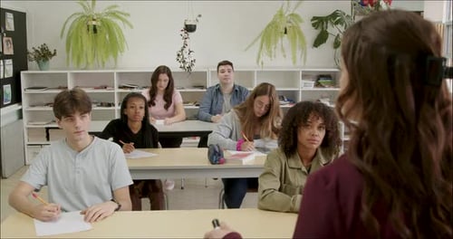 Students Learning in School Class Room. High School or College Class Raising Hand Asking Questions