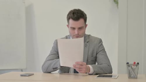 Excited Young Adult Celebrates Office Success