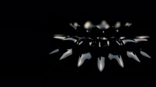 Spinning Black Ferrofluid Against A Dark Background