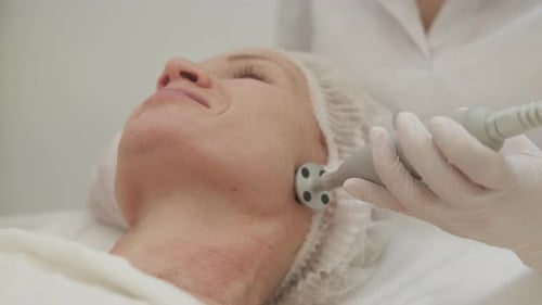 Woman Receiving Facial Treatment at Beauty Clinic