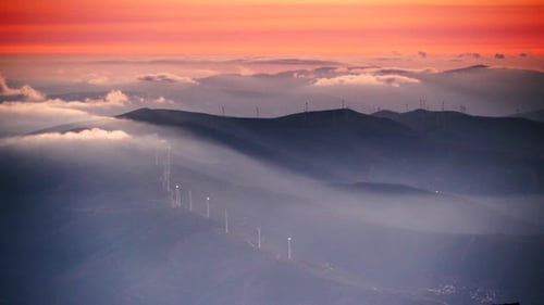 Wind Turbines at Sunset above Clouds in Serra da Estrela, Portugal.