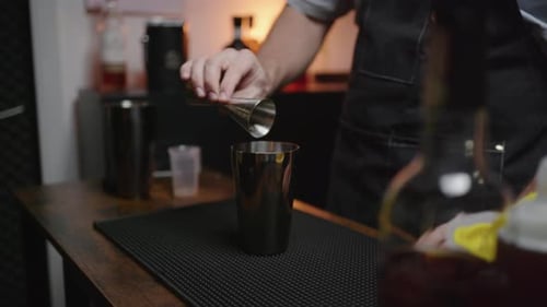 Bartender Pours Drink into Shaker