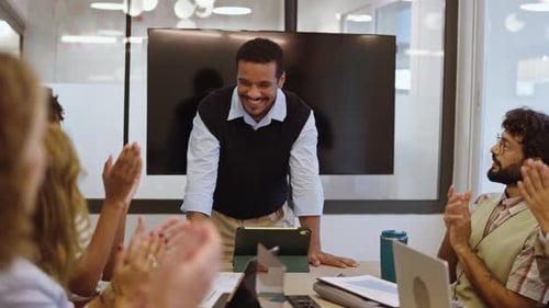 Business Team Clapping in Modern Office Conference Room