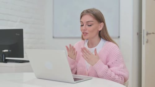 Creative Young Woman Doing Video Chat via Laptop