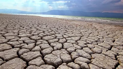 Cracked Earth Landscape Under a Partly Cloudy Sky