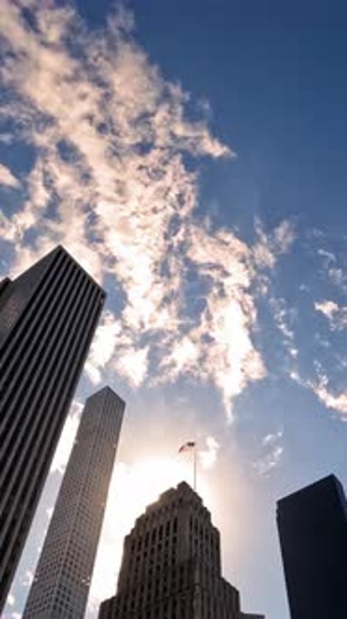 Timelapse Skyscrapers Reaching Toward the Sky An Urban View Framed Against a Vibrant Blue Sky